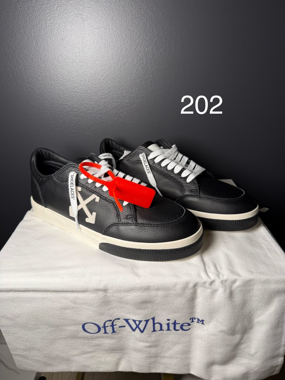 Off-White Black Leather Low-Top Sneakers with White Accents and Red Zip-Tie